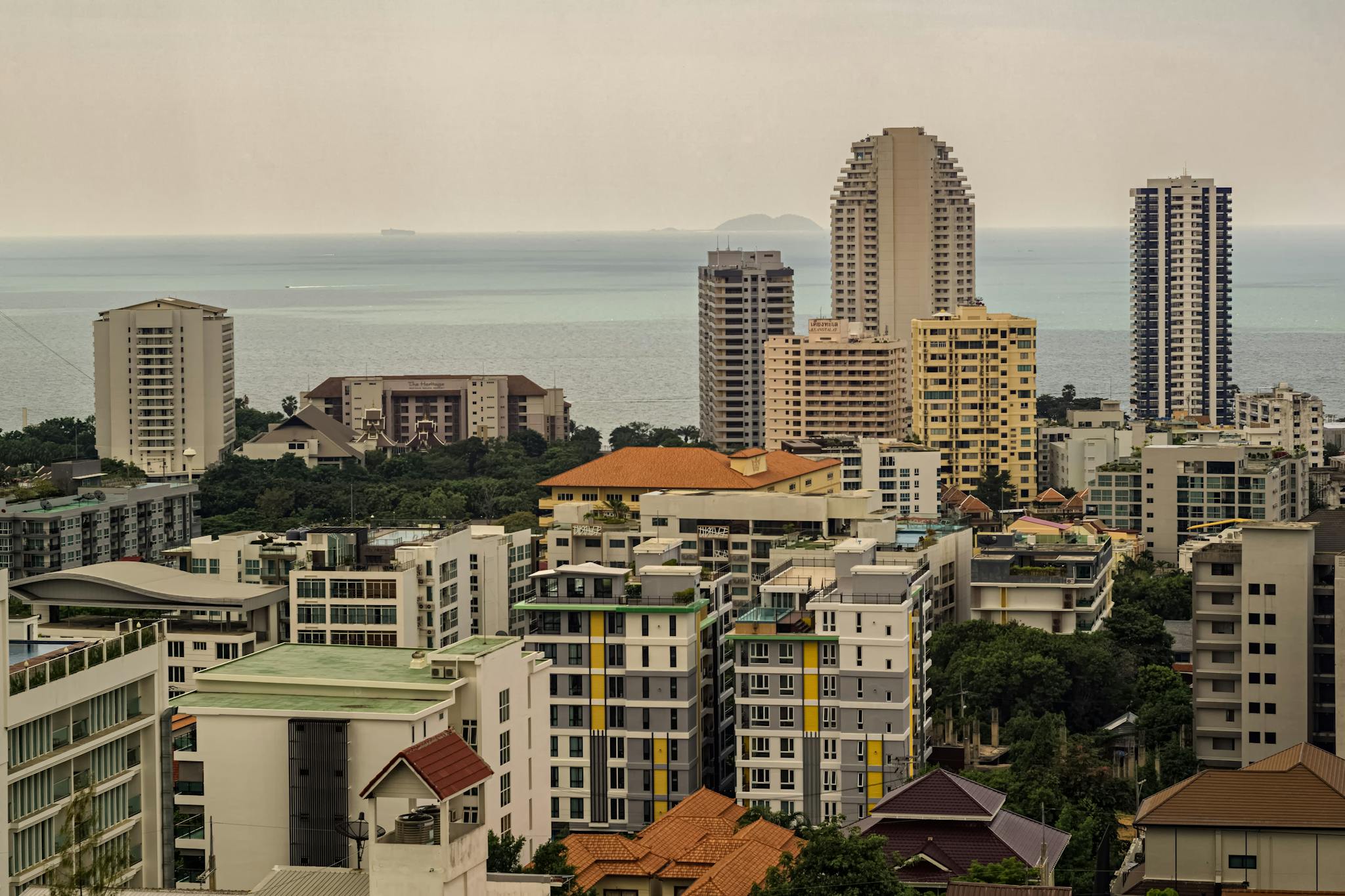 High-rise buildings overlooking the ocean in Pattaya, Thailand, offering a panoramic view.